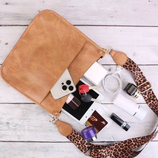 Holy Mango Store tan leather casual shoulder purse for women with leopard strap open showing phone keys charger lipstick