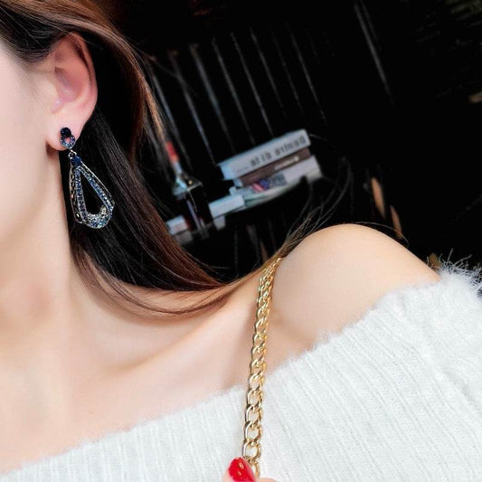 Holy Mango Store retro rhinestone drop earrings teardrop crystal drops on model wearing white off shoulder sweater gold chain