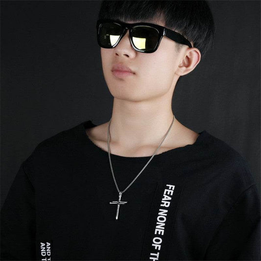 Faith jewelry for men silver cross necklace worn by young man in black shirt and sunglasses