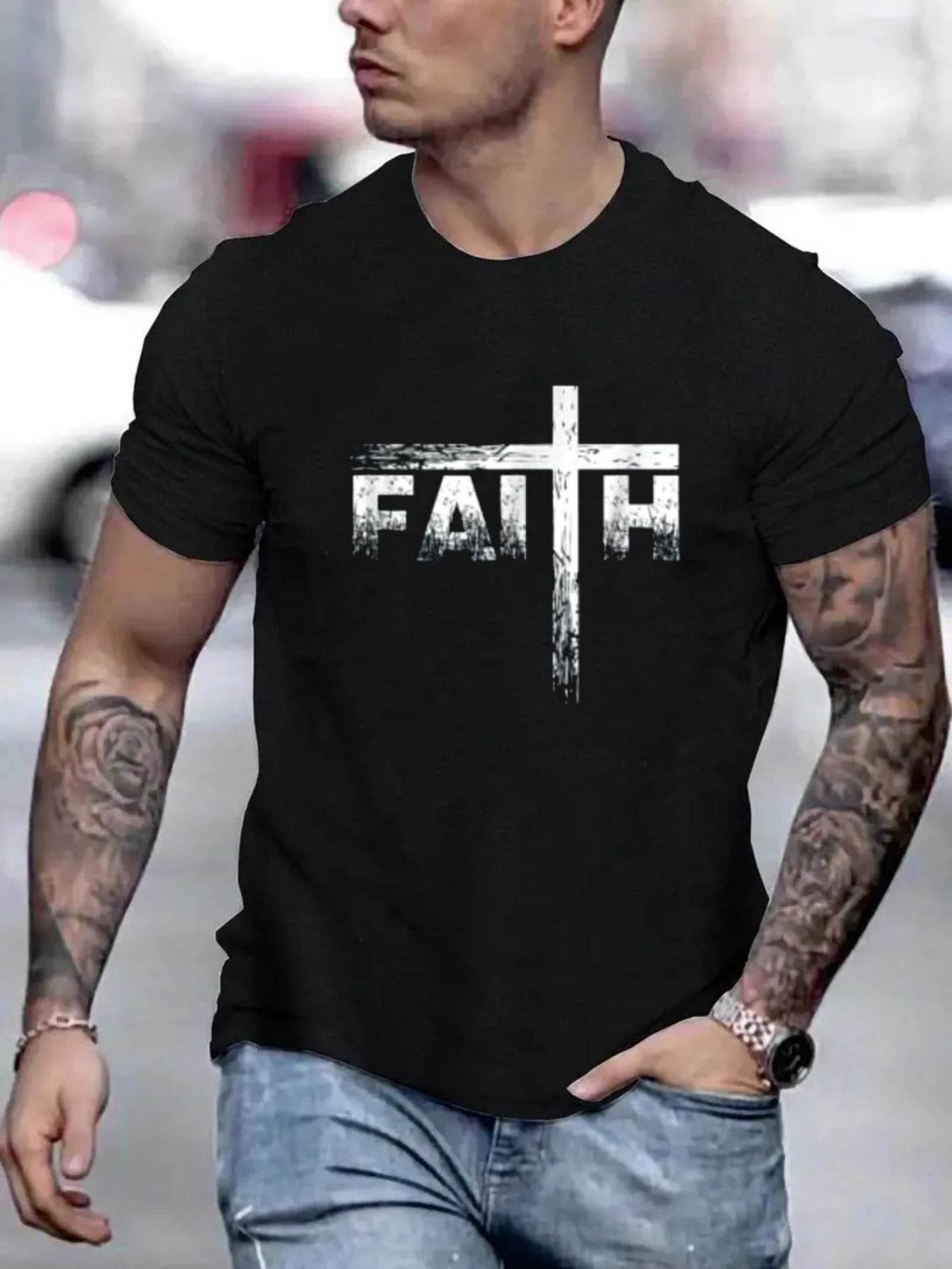 Black faith print t-shirt for men with white cross design, worn by tattooed man in casual jeans