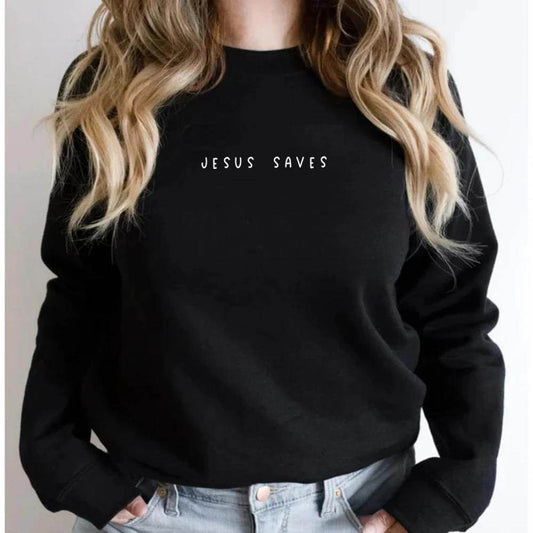 Black Jesus Saves sweatshirt from Holy Mango Store worn by woman with hands in light denim jeans pockets