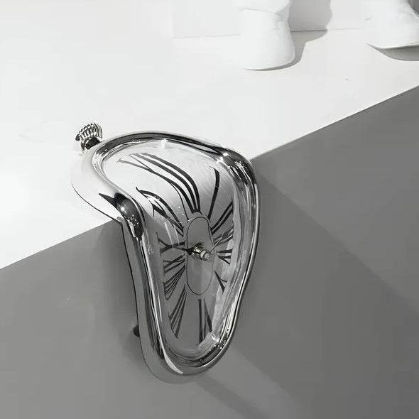 Holy Mango Store DALI inspired melting clock silver tabletop sculpture draped over a shelf edge modern home decor