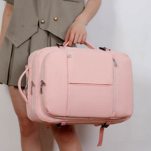 Holy Mango Store pink convertible overnight bag held by woman large capacity travel backpack with multiple pockets