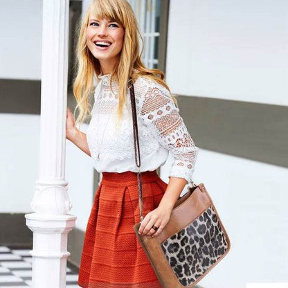 Holy Mango Store tan leather casual shoulder purse for women with leopard panel shown on smiling woman in lace top and red skirt