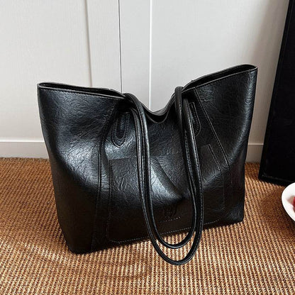 Black retro shoulder bag for women with a textured finish and double straps from Holy Mango Store