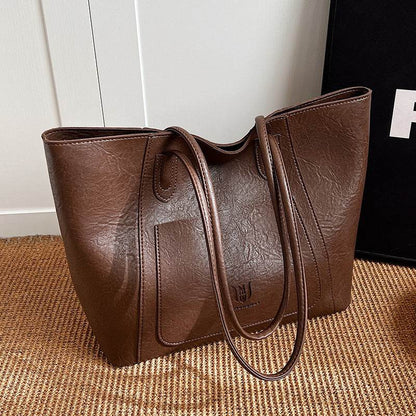 Brown retro shoulder bag for women with long straps and textured leather from Holy Mango Store