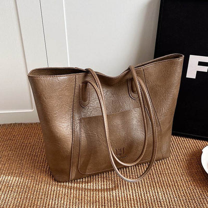 Brown retro shoulder bag for women made of textured leather with double straps and front pocket