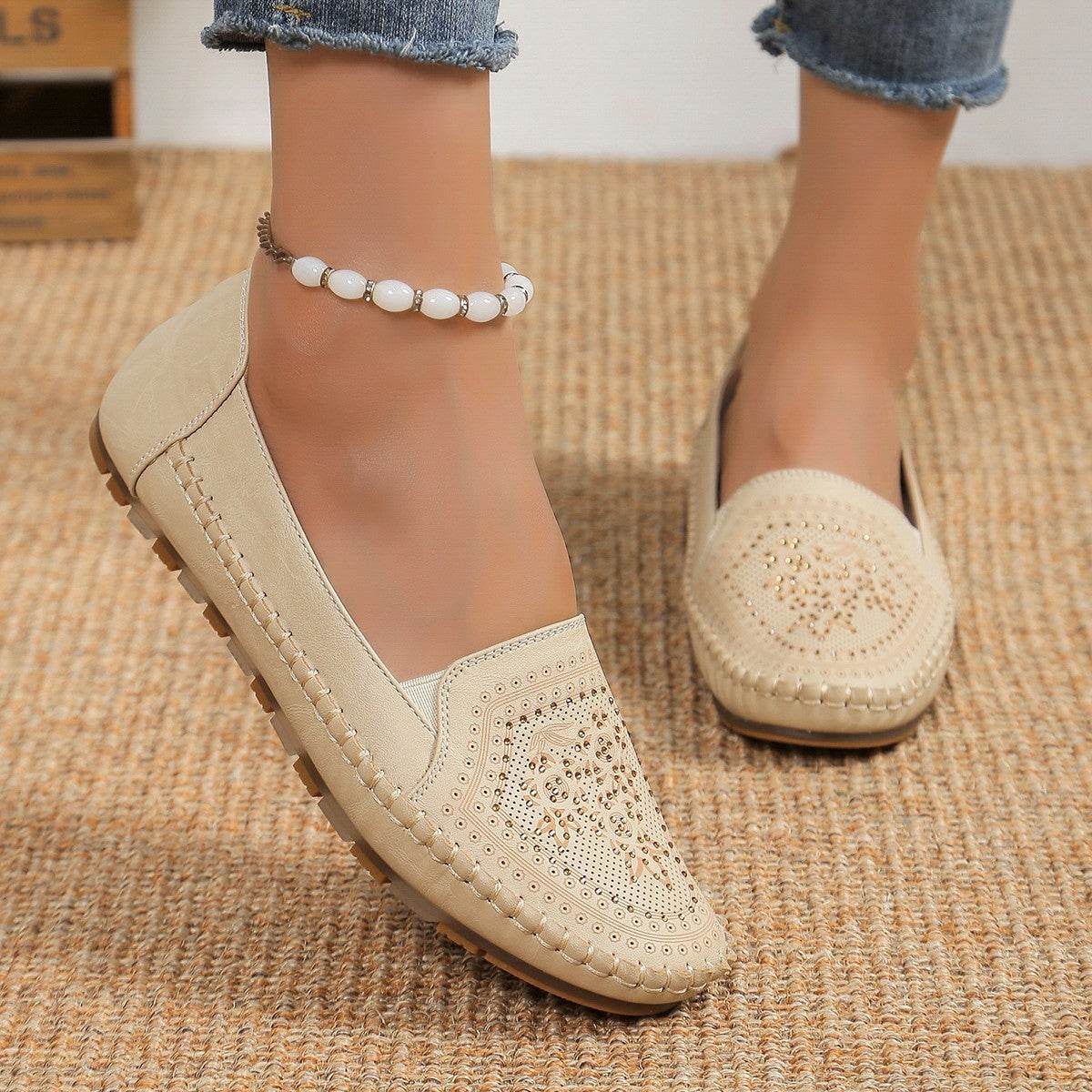 Beige casual slip-on shoes for women with decorative perforations and stitched detailing
