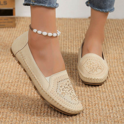 Beige casual slip-on shoes for women with decorative perforations and stitched detailing