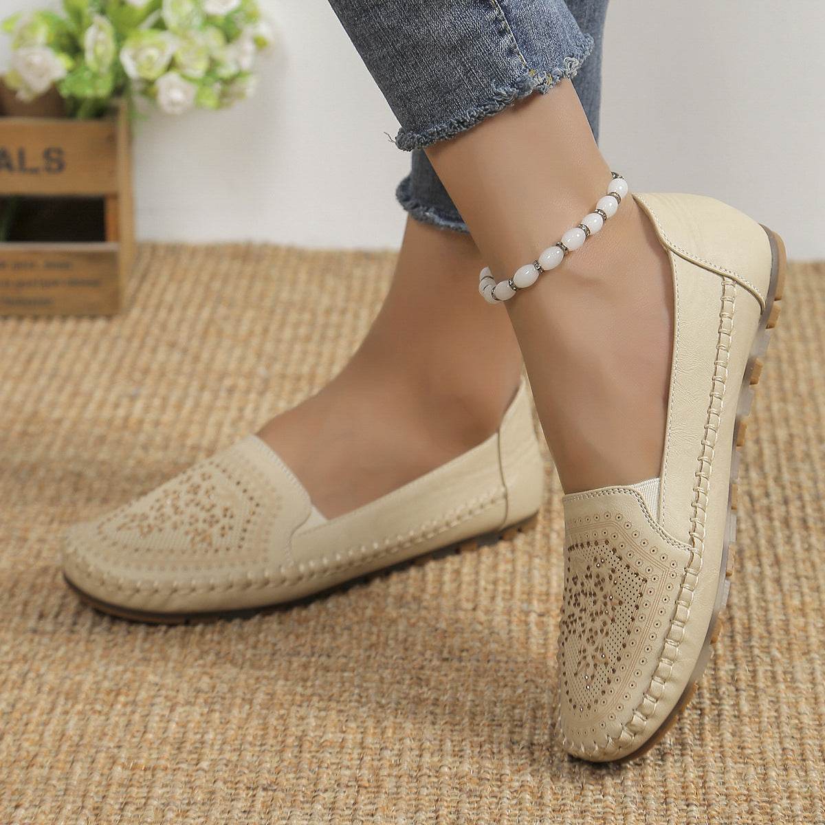Beige casual slip-on shoes for women with decorative perforations and stitching detail