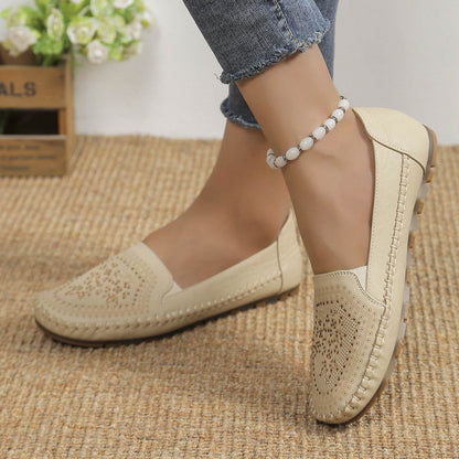 Beige casual slip-on shoes for women with decorative perforations and stitching detail