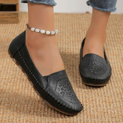 Black casual slip-on shoes for women with perforated design and comfortable sole from Holy Mango Store