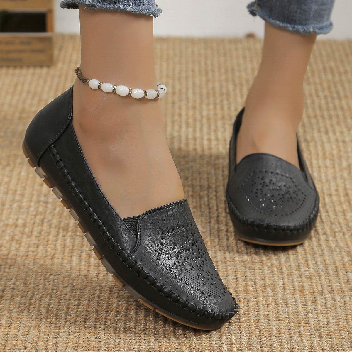 Black casual slip-on shoes for women with perforated design and stitched details from Holy Mango Store