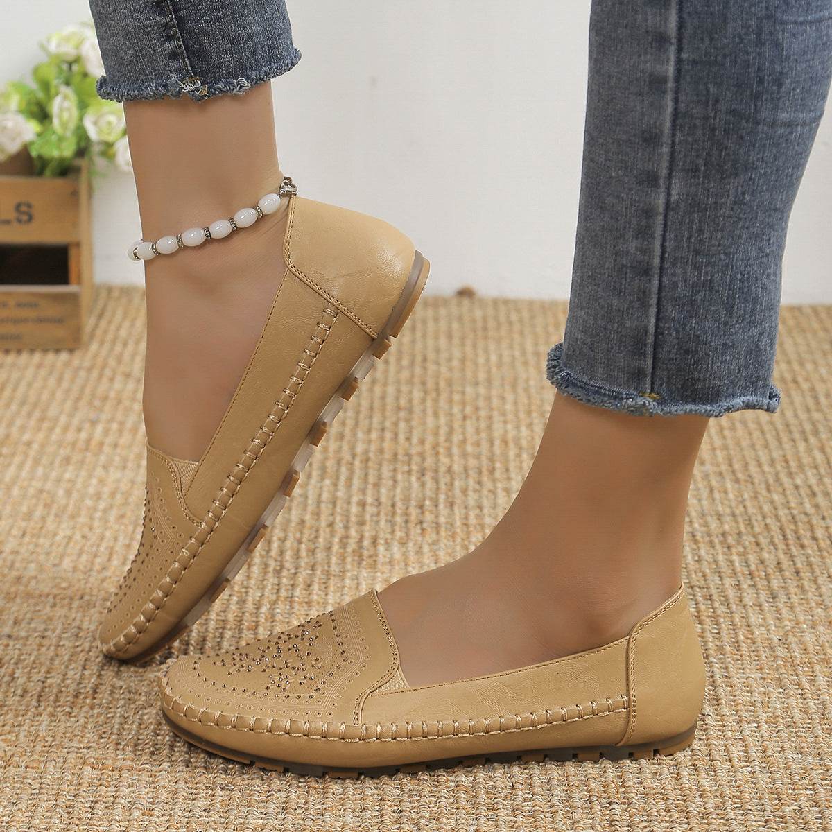 Beige casual slip-on shoes for women from Holy Mango Store worn with blue jeans on a carpet