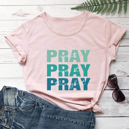 Pink faith themed t shirt with green and blue Pray text paired with denim shorts and sunglasses