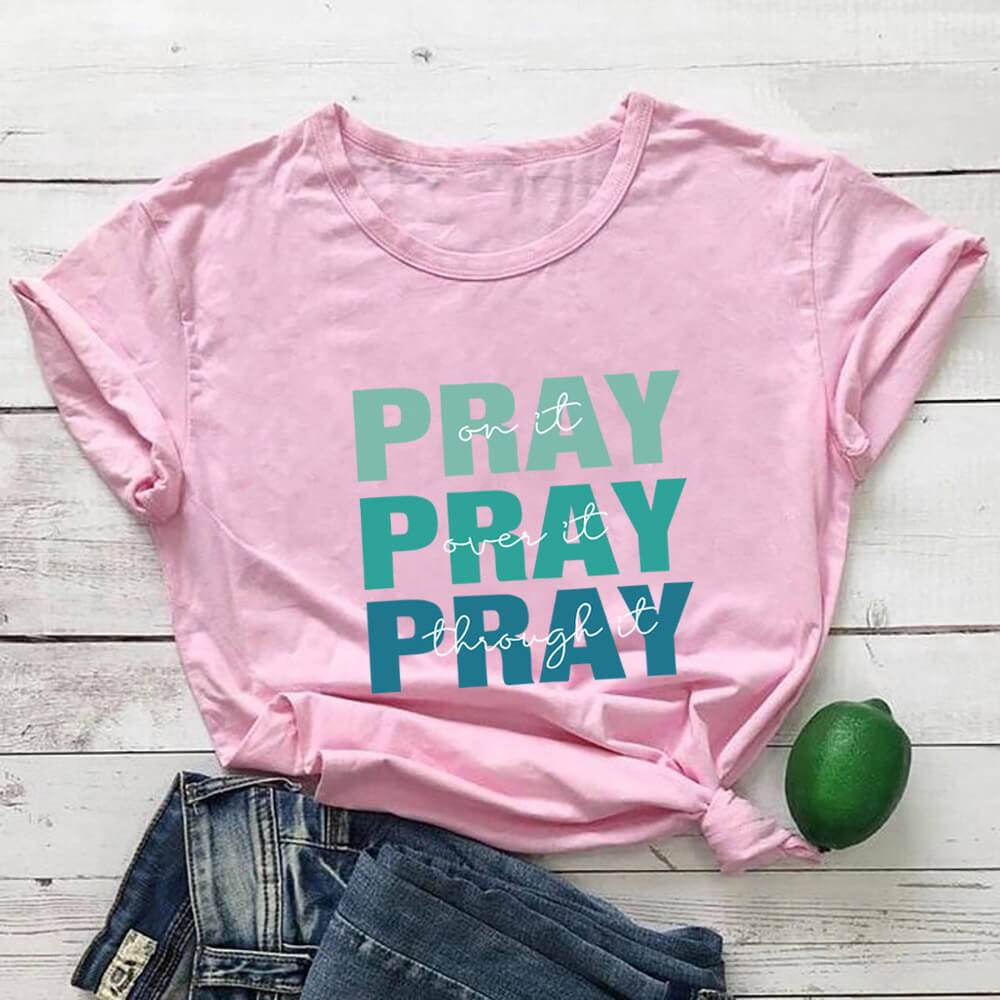 Pink faith themed t shirt with pray text design from Holy Mango Store paired with denim shorts