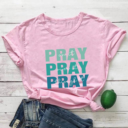 Pink faith themed t shirt with pray text design from Holy Mango Store paired with denim shorts