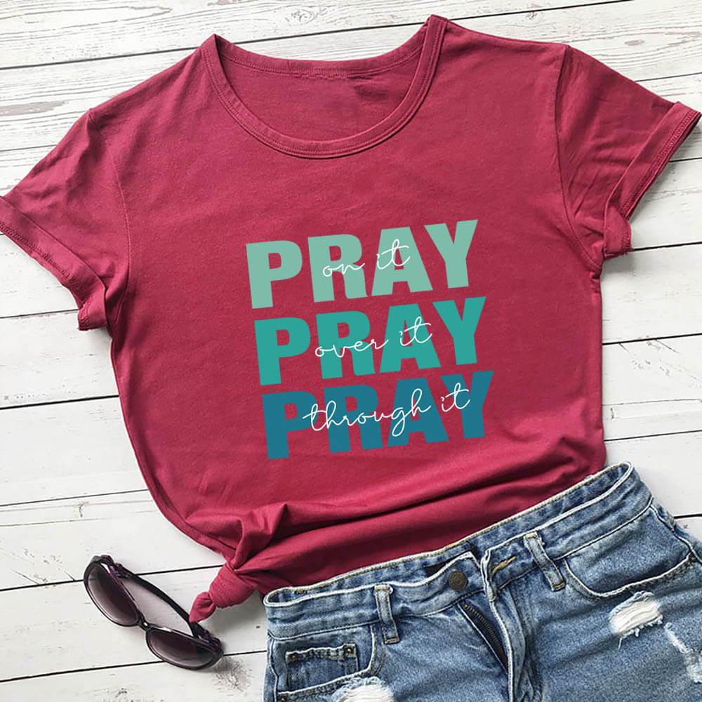 Holy Mango Store faith themed t shirt in red with Pray design styled with denim shorts and sunglasses