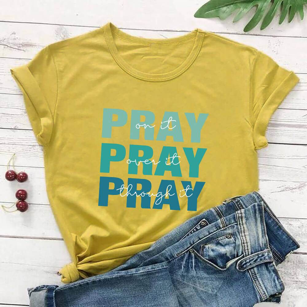 Yellow faith themed t shirt from Holy Mango Store with blue Pray text and casual rolled sleeves