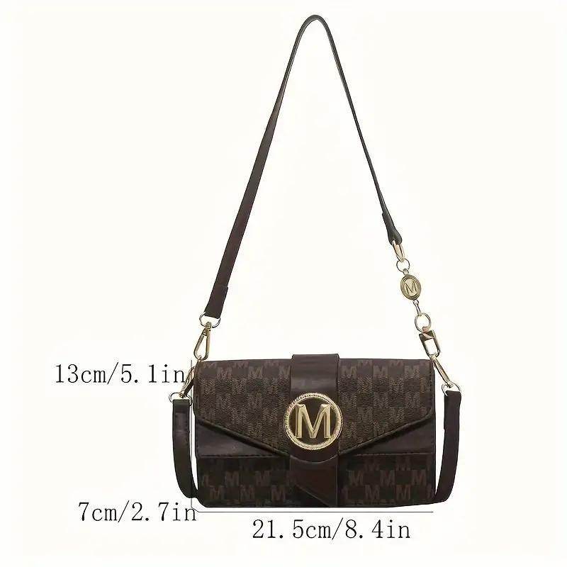 Holy Mango Store brown monogram small crossbody purse for everyday use with gold M clasp and adjustable strap