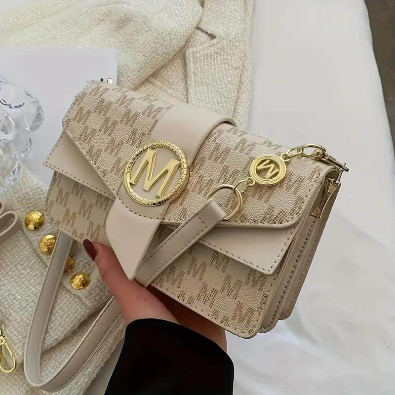 Holy Mango Store beige monogram small crossbody purse for everyday use with gold M emblem and detachable strap