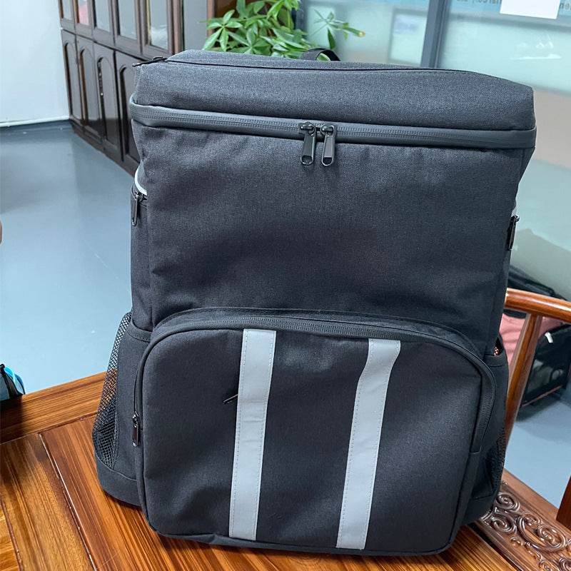 Holy Mango large insulated backpack cooler in black with top zip front pocket reflective vertical stripes and side mesh pockets
