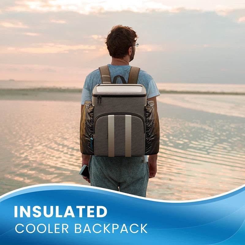Holy Mango Store large insulated backpack cooler worn by man at beach sunset with side bottle pockets