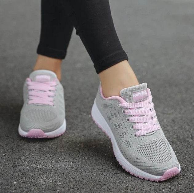 Women's lightweight sports sneakers in gray with pink laces from Holy Mango Store on pavement