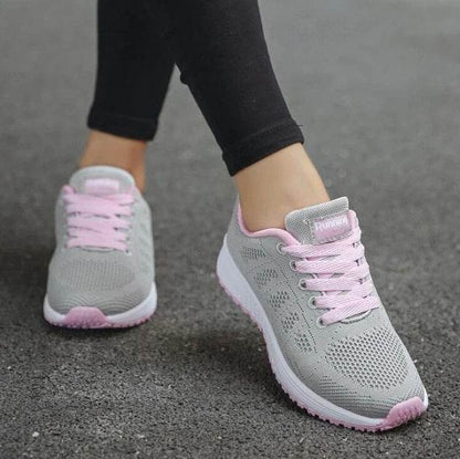 Women's lightweight sports sneakers in gray with pink laces from Holy Mango Store on pavement