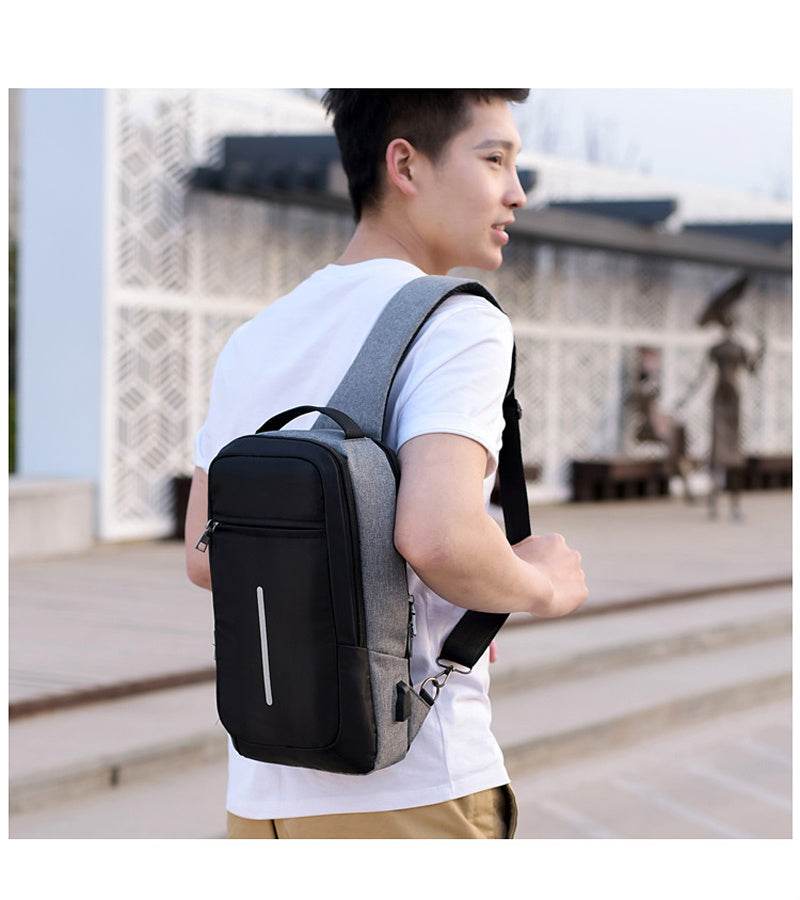Holy Mango Store anti-theft chest bag with USB charging gray black sling worn by man for travel commuting