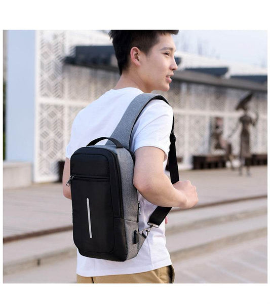 Holy Mango Store anti-theft chest bag with USB charging gray black sling worn by man for travel commuting