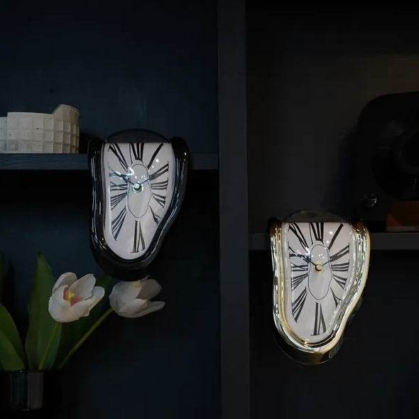 Holy Mango Store DALI inspired melting clock pair black and gold frames white roman faces on dark shelf