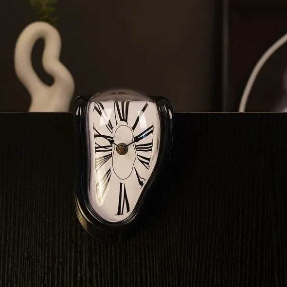 DALI inspired melting clock by Holy Mango Store draped over shelf edge black frame white face Roman numerals