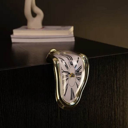 Holy Mango Store DALI inspired melting clock gold frame white Roman numerals draped over dark wood table edge surreal decor accent