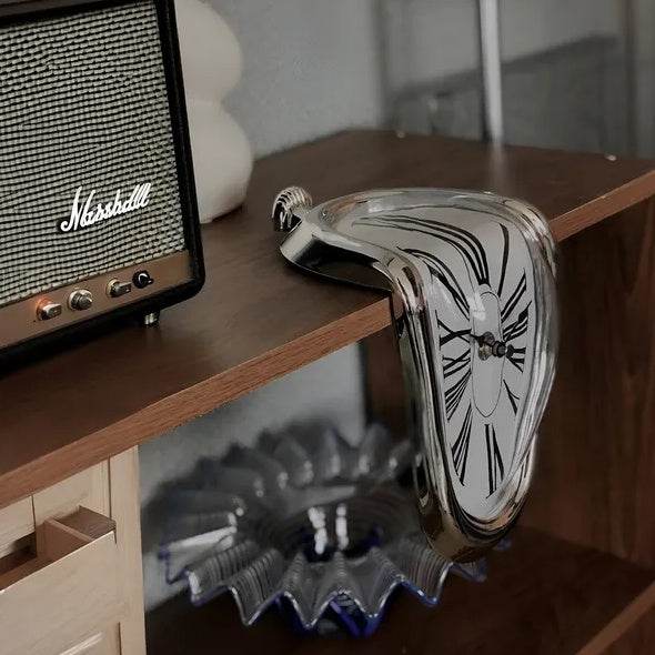 Holy Mango Store DALI inspired melting clock draped over wooden shelf beside vintage radio and glass bowl