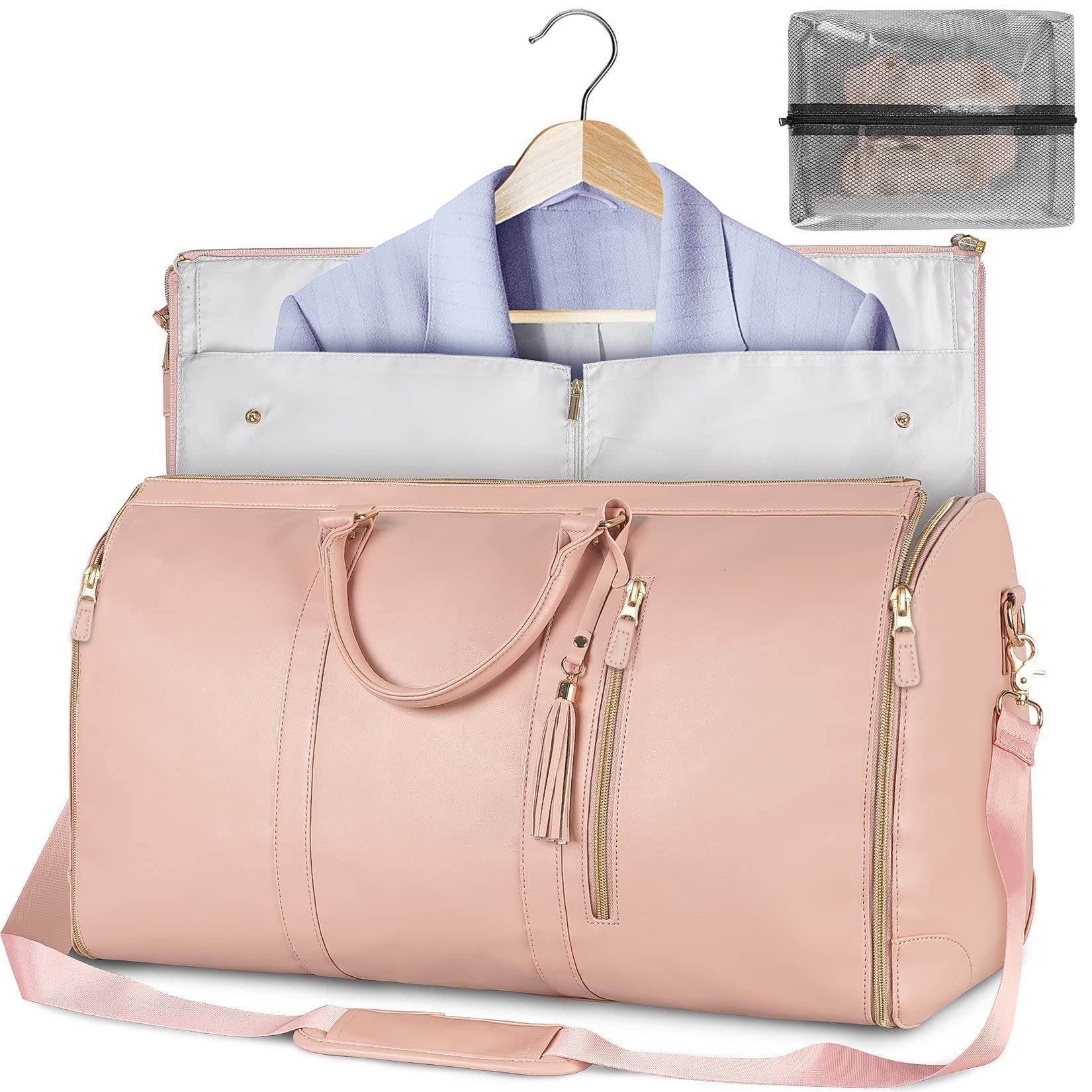 Holy Mango Store pink carry on duffle bag with garment compartment showing hanging blouse and shoulder strap