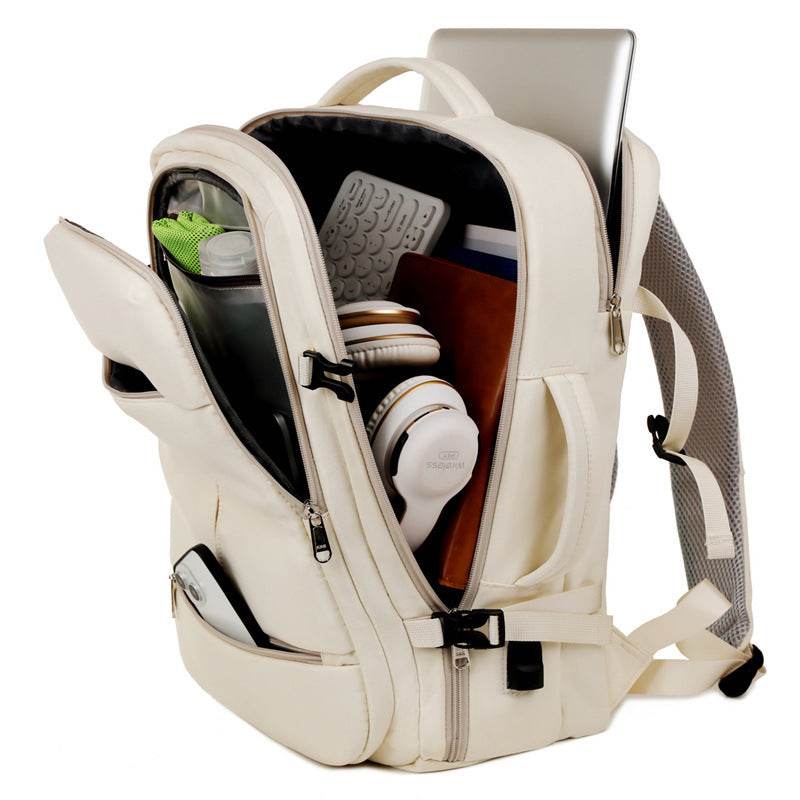 Holy Mango cream bag open showing laptop headphones water bottle notebook and organizer large capacity travel backpack