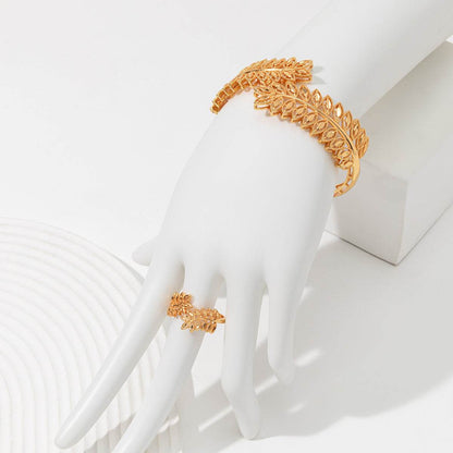 Gold wheat leaf bracelet set and matching ring displayed on white mannequin hand from Holy Mango Store