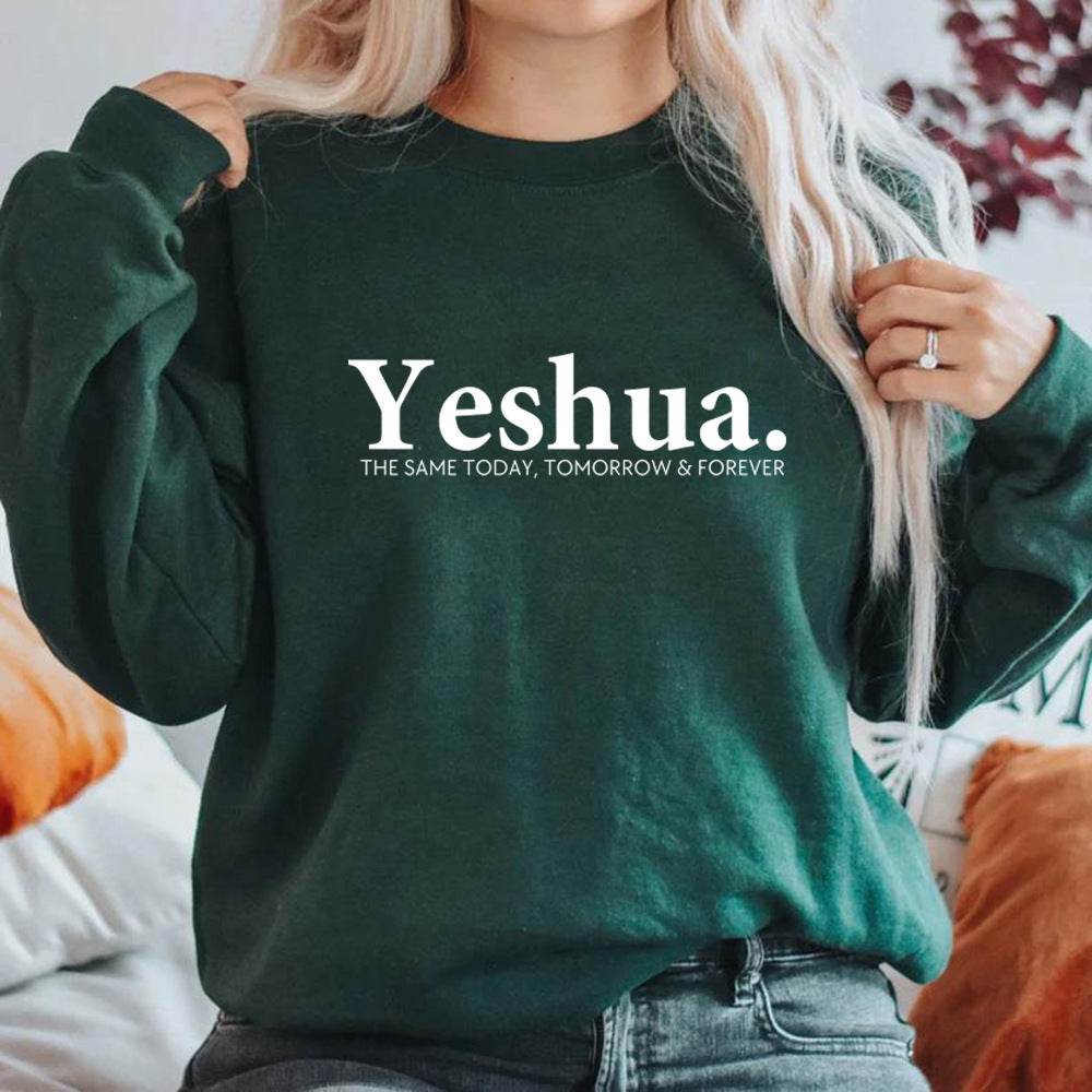 Vintage Yeshua sweatshirt in dark green with white lettering worn by woman, faith-based apparel from Holy Mango Store