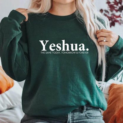 Vintage Yeshua sweatshirt in dark green with white lettering worn by woman, faith-based apparel from Holy Mango Store